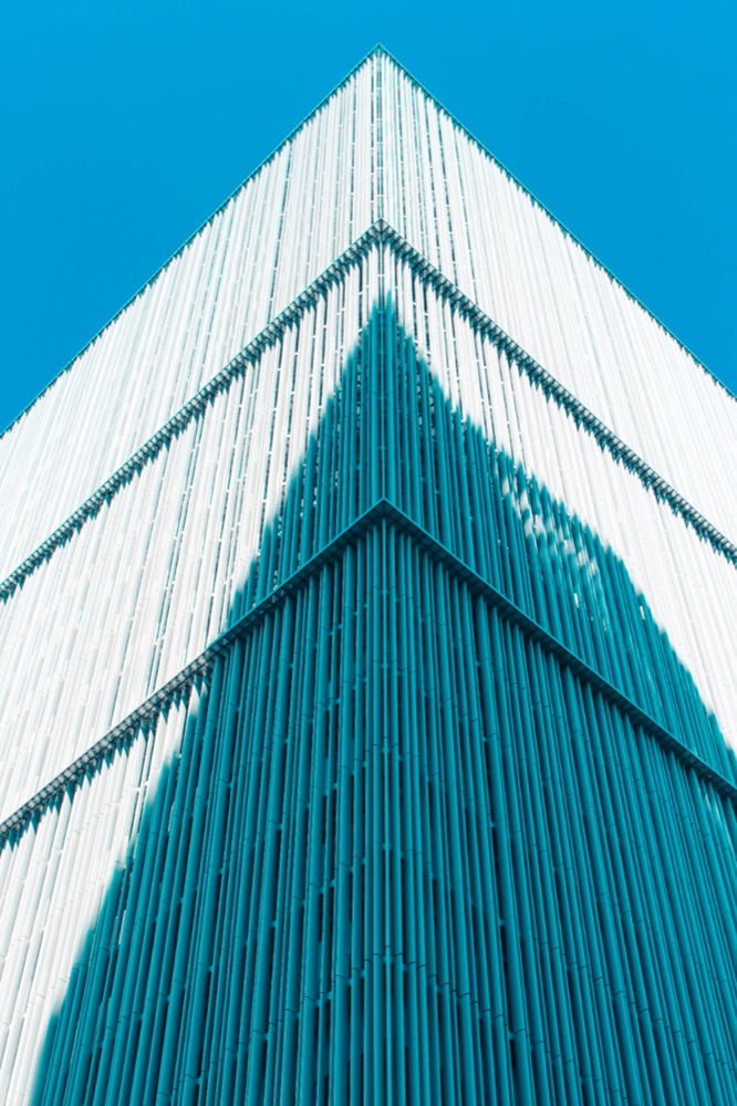 A clear glass office building, representing checking the record before you act